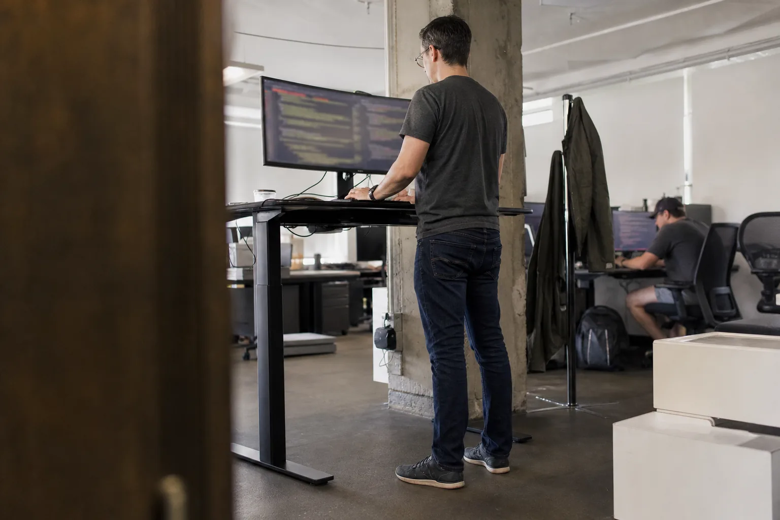 Engineer integrating screening into an onboarding flow at a standing desk