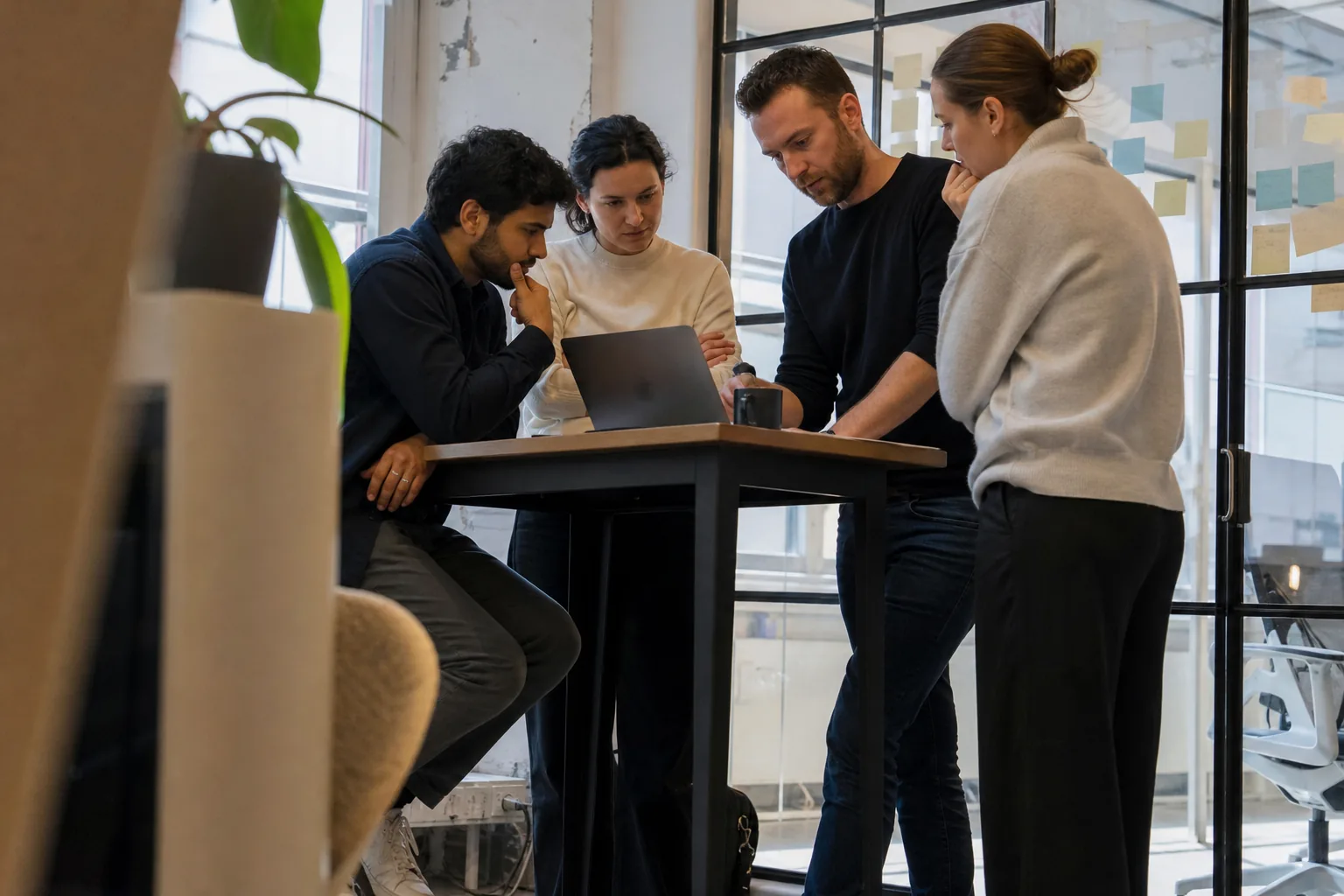 Fintech compliance lead reviewing onboarding screening results on a laptop